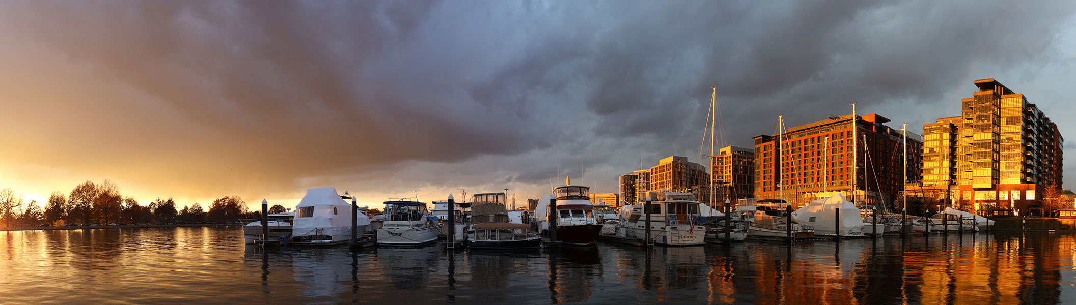 Panorama of Marina and Buildings in Gold and Red Sunset Light.